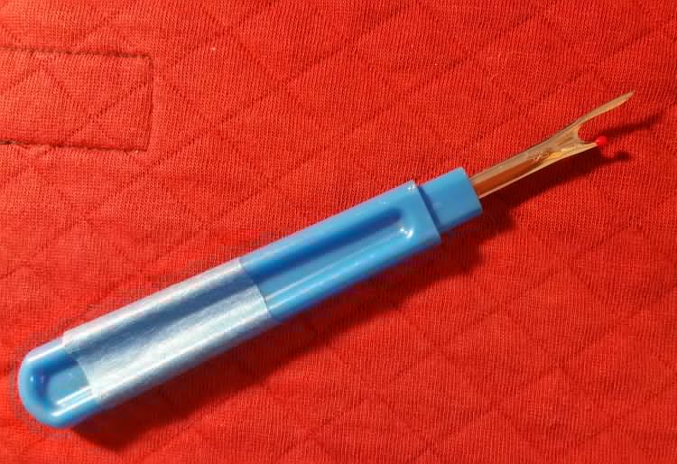 A seam ripper for cutting and pulling on individual threads